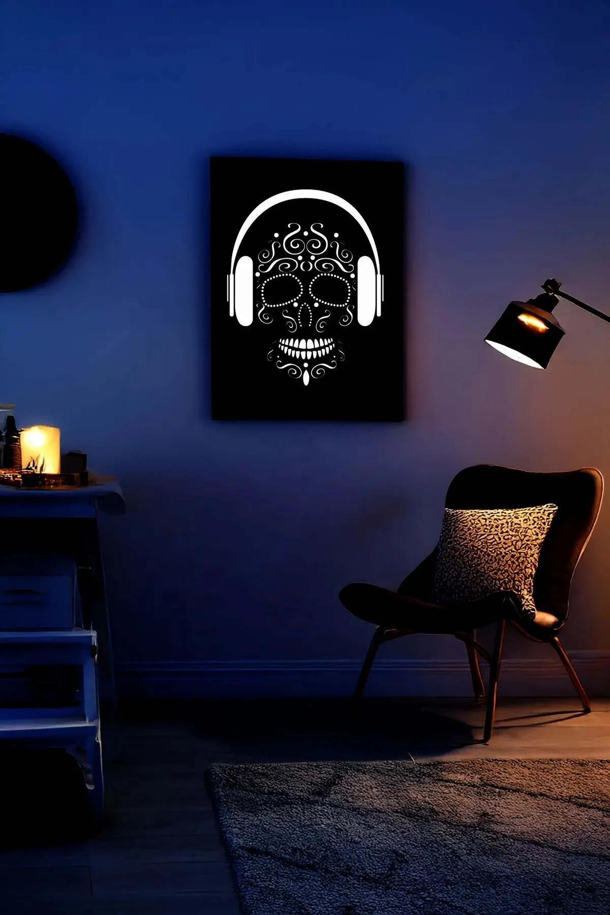 Black and White Skull Canvas Print Side Profile Hanging on Wall with Headphones and Decorative Patterns in Dark Room Setting