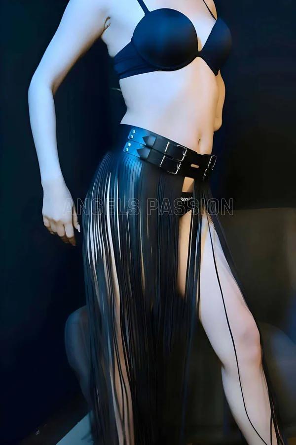 Black faux leather fringe skirt harness with wide double buckle belt and floor-length narrow fringe strips