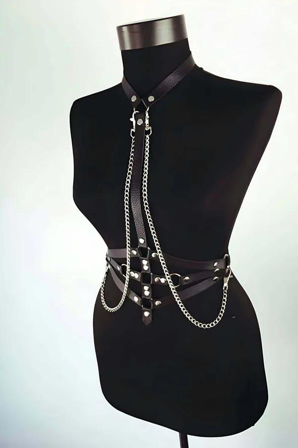black faux leather body harness with silver curb chains draped from neck collar to waist belt with rivet studs