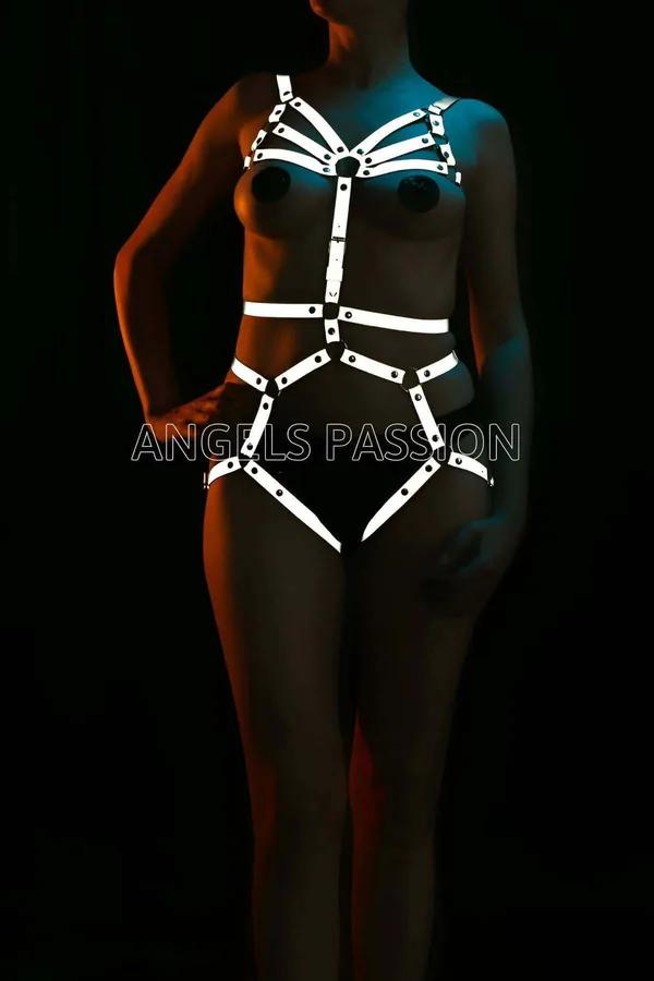 Reflective full body harness with white glowing star chest straps and waist bands under UV lighting