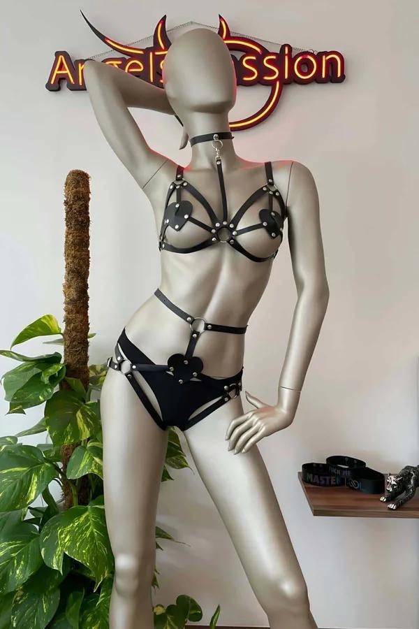 Black faux leather harness set with heart accents silver O-rings and connected choker on mannequin