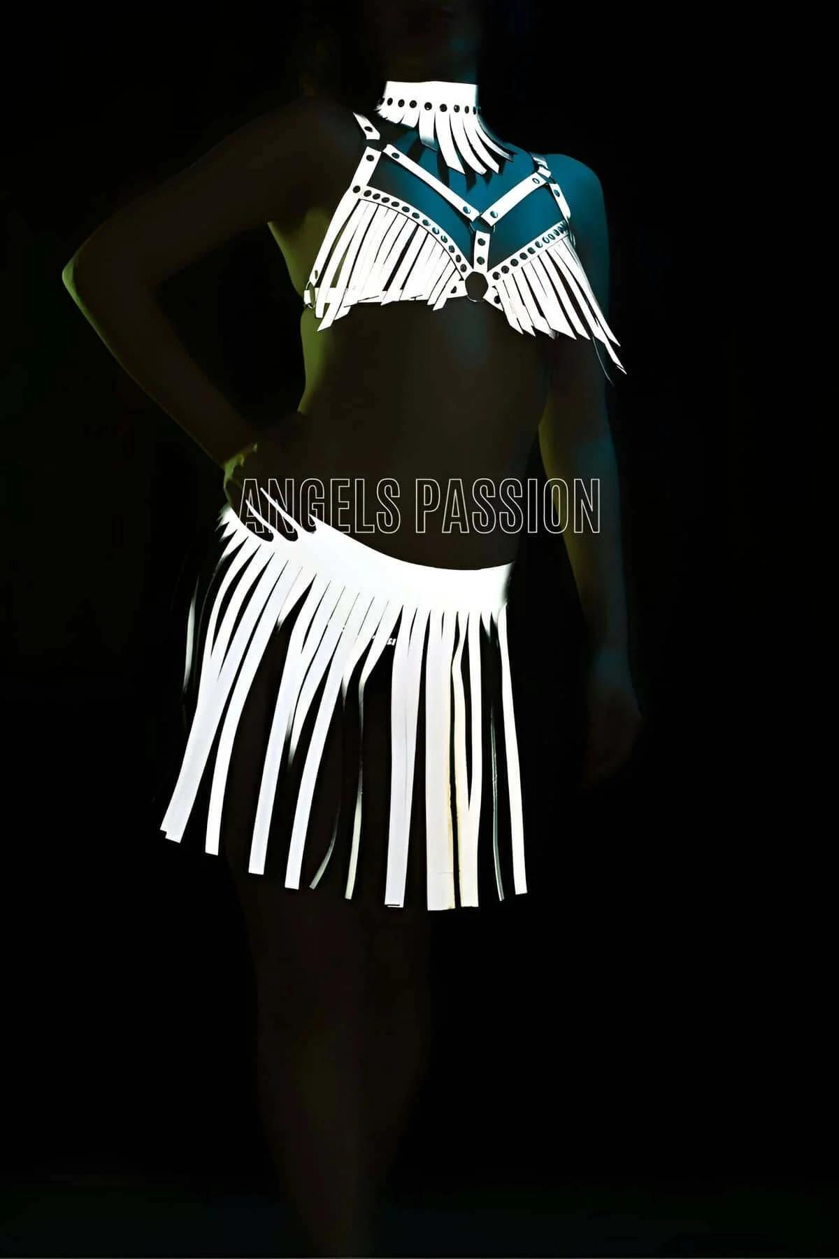 White reflective faux leather fringe harness set with studded halter top and matching mini fringe skirt glowing under direct
