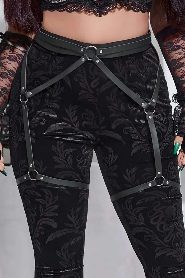 black faux leather thigh garter harness with silver O-rings and wide adjustable waist belt worn over textured leggings