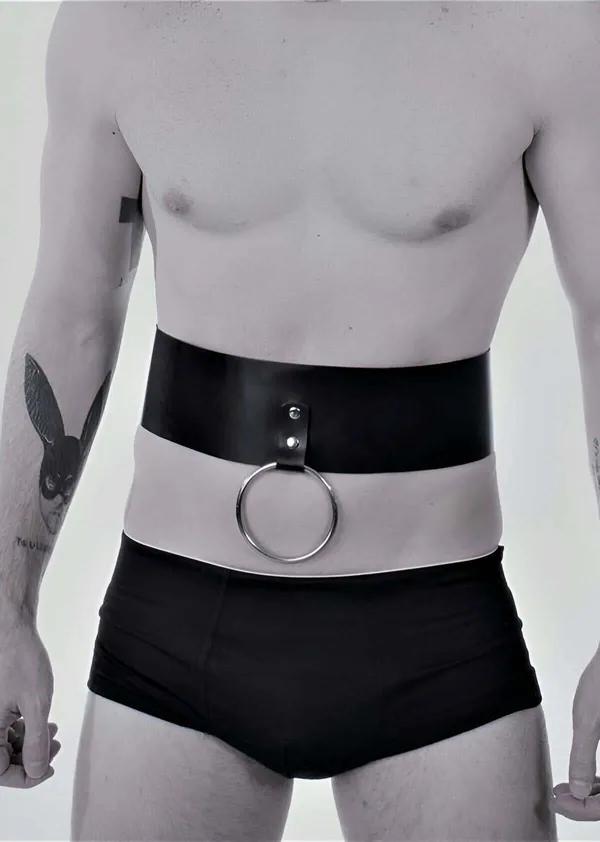 black wide faux leather waist harness with front silver O-ring worn by male model, smooth black band approx 10 cm tall