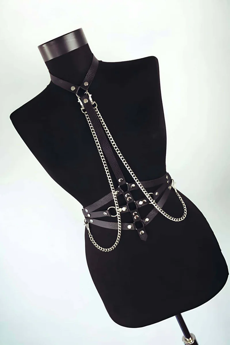 Back view of adjustable black faux leather body harness with chains