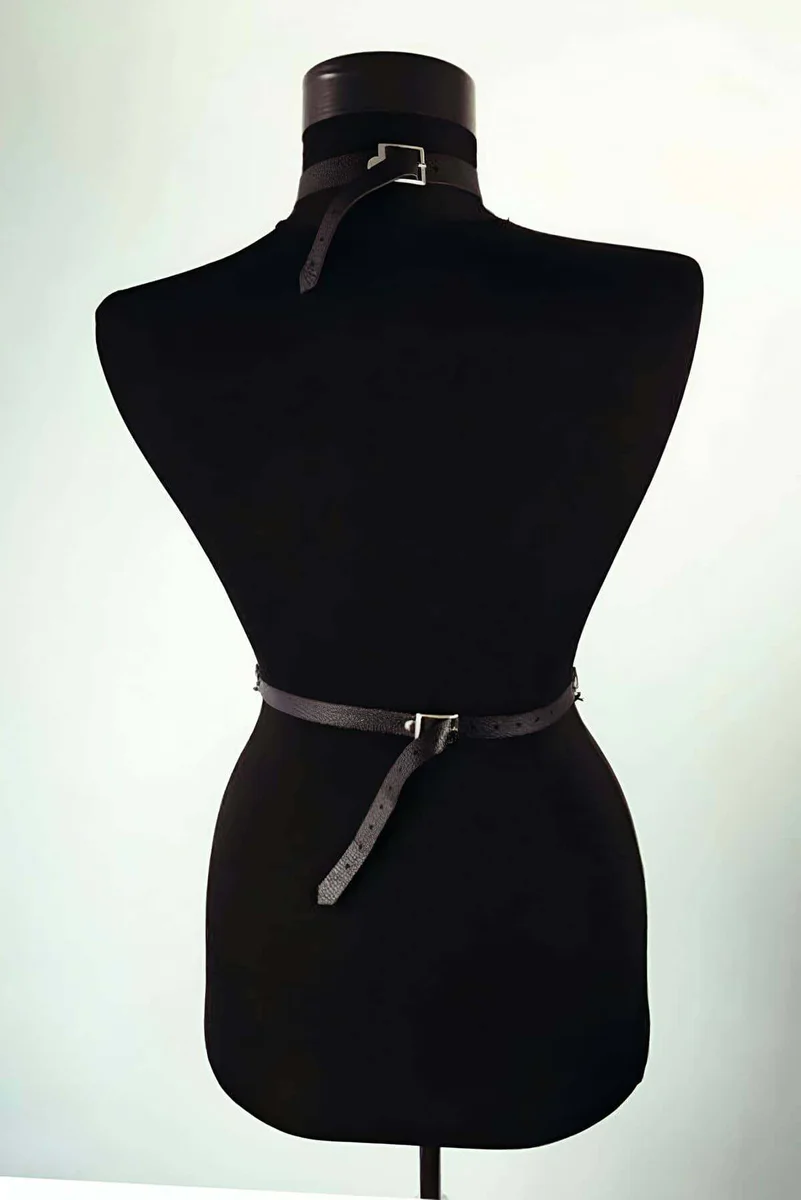 Black faux leather body harness side profile showing strap configuration and chain drape