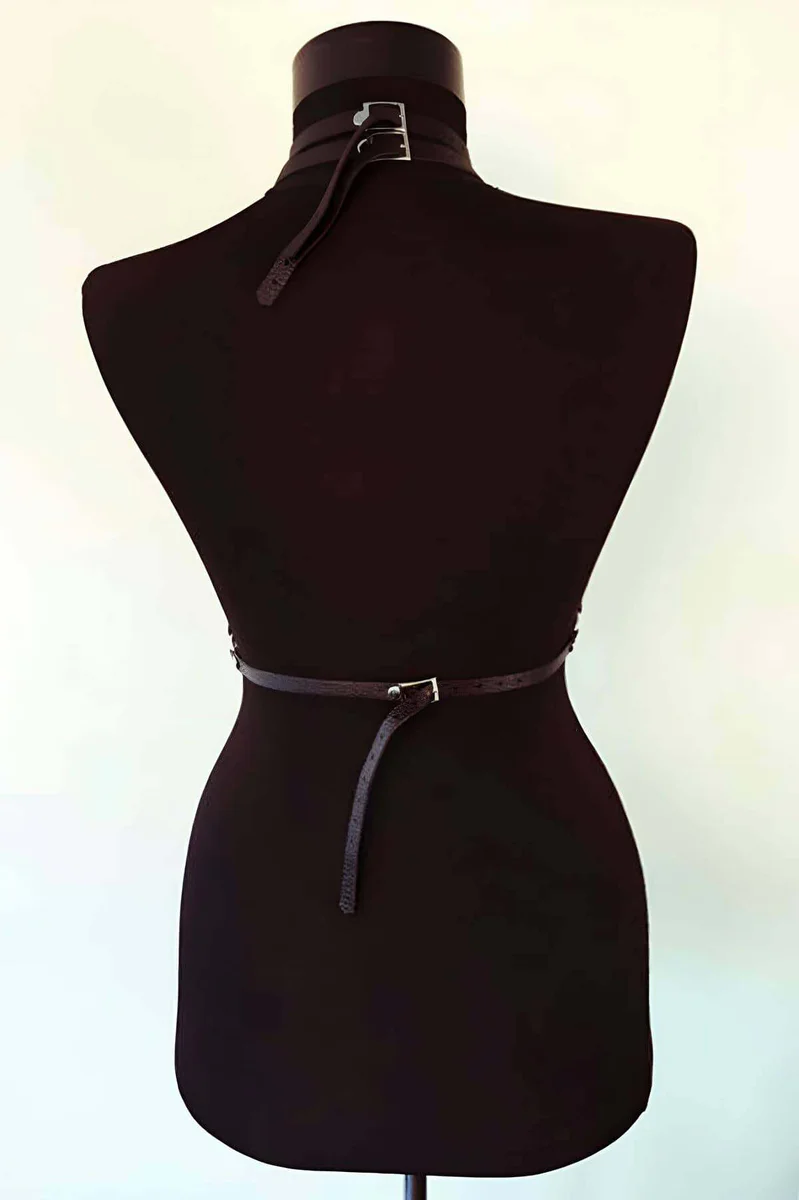 Black chest harness O-ring detail with adjustable straps and buckle closure