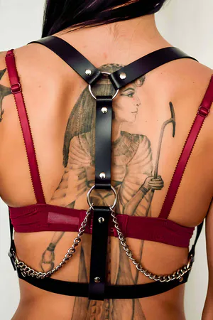 Black faux leather full body harness with silver O-rings and detachable chain detail