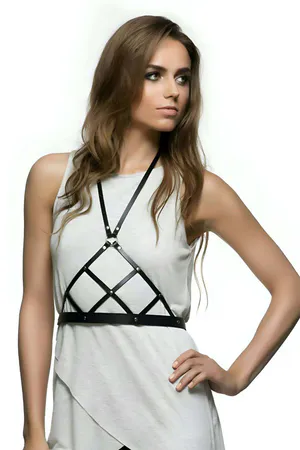 Black faux leather geometric body harness with silver studs and adjustable straps