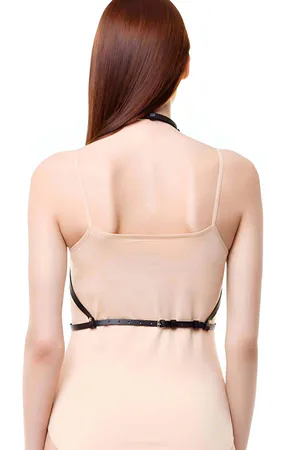 Black faux leather star chest harness with adjustable straps on a woman