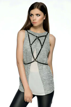 Black faux leather geometric body harness with O-ring accents on a woman