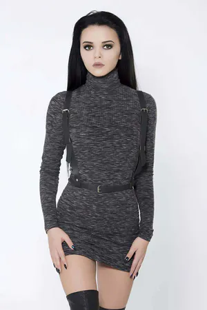Black faux leather adjustable body harness worn by a model
