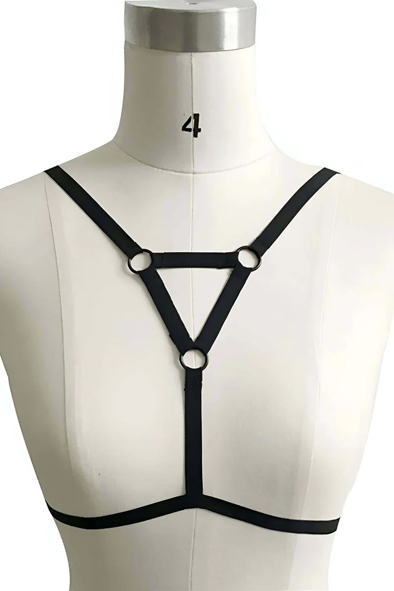 Black strappy chest harness with O-ring detail close-up
