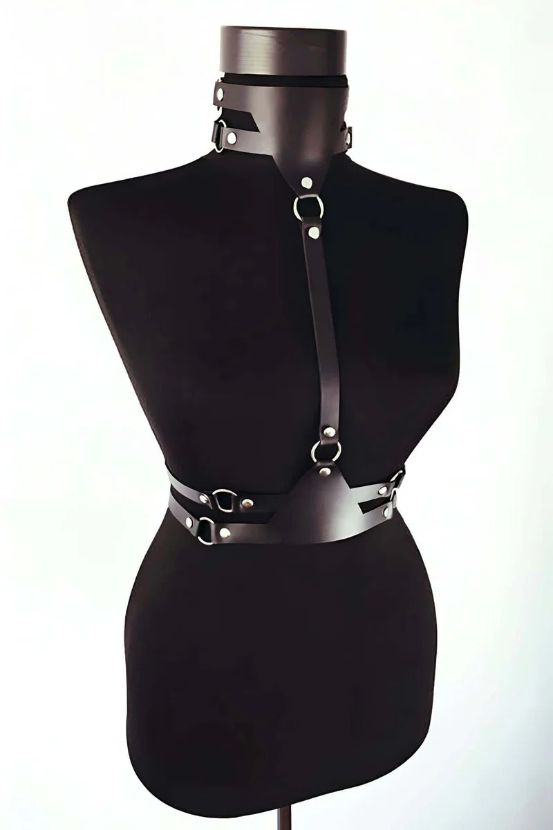 Black faux leather body harness with multiple O-ring accents on chest and waist
