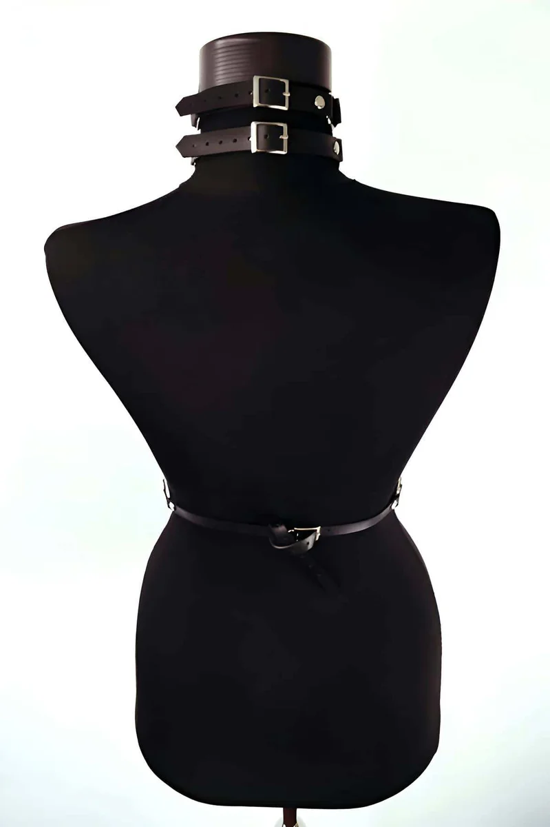 Back view black faux leather body harness with silver buckles and chain detail