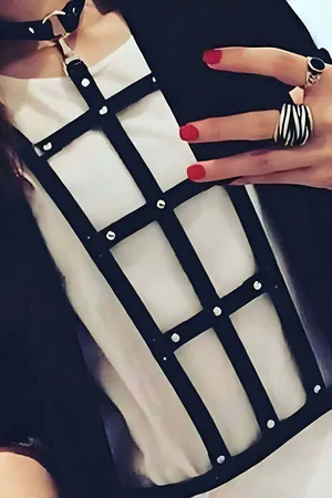 Black grid faux leather body harness with metallic stud details and adjustable straps
