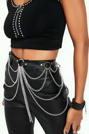 Black faux leather waist harness with multiple silver chain cascades and O-ring details, worn on model