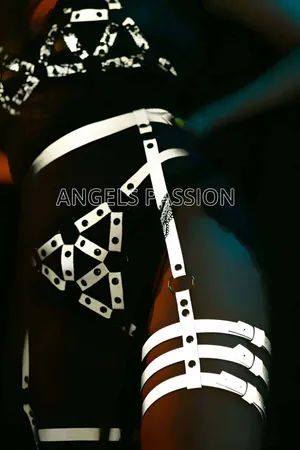 Silver reflective full body harness with geometric patterns and matching thigh cuffs, shown on a model against a dark backgro