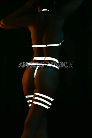 Silver reflective full body harness with geometric patterns and matching thigh cuffs, shown on a model against a dark backgro