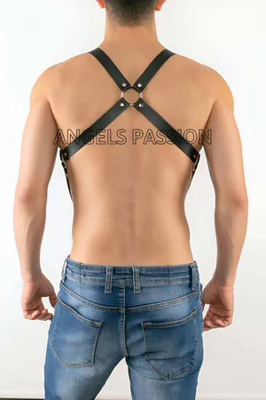 Black faux leather chest harness with adjustable straps and central O-ring.