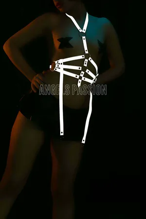 White reflective O-ring body harness with adjustable straps worn by a model