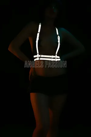 Silver reflective chest harness with adjustable straps worn by a model.