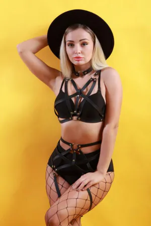 Black vegan leather strappy body harness and garter set on model