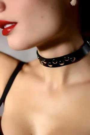 Black faux leather choker with silver buckle and strap details
