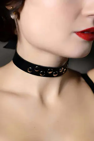 Black faux leather choker with silver buckle and strap details