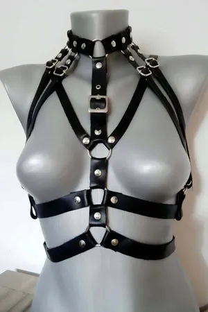 Black faux leather chest harness with adjustable straps and silver hardware