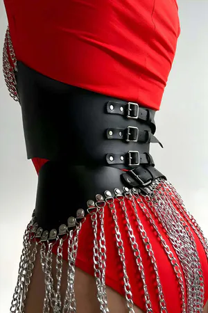 Black Faux Leather Bustier and Skirt Set with Layered Silver Chains worn over red bodysuit