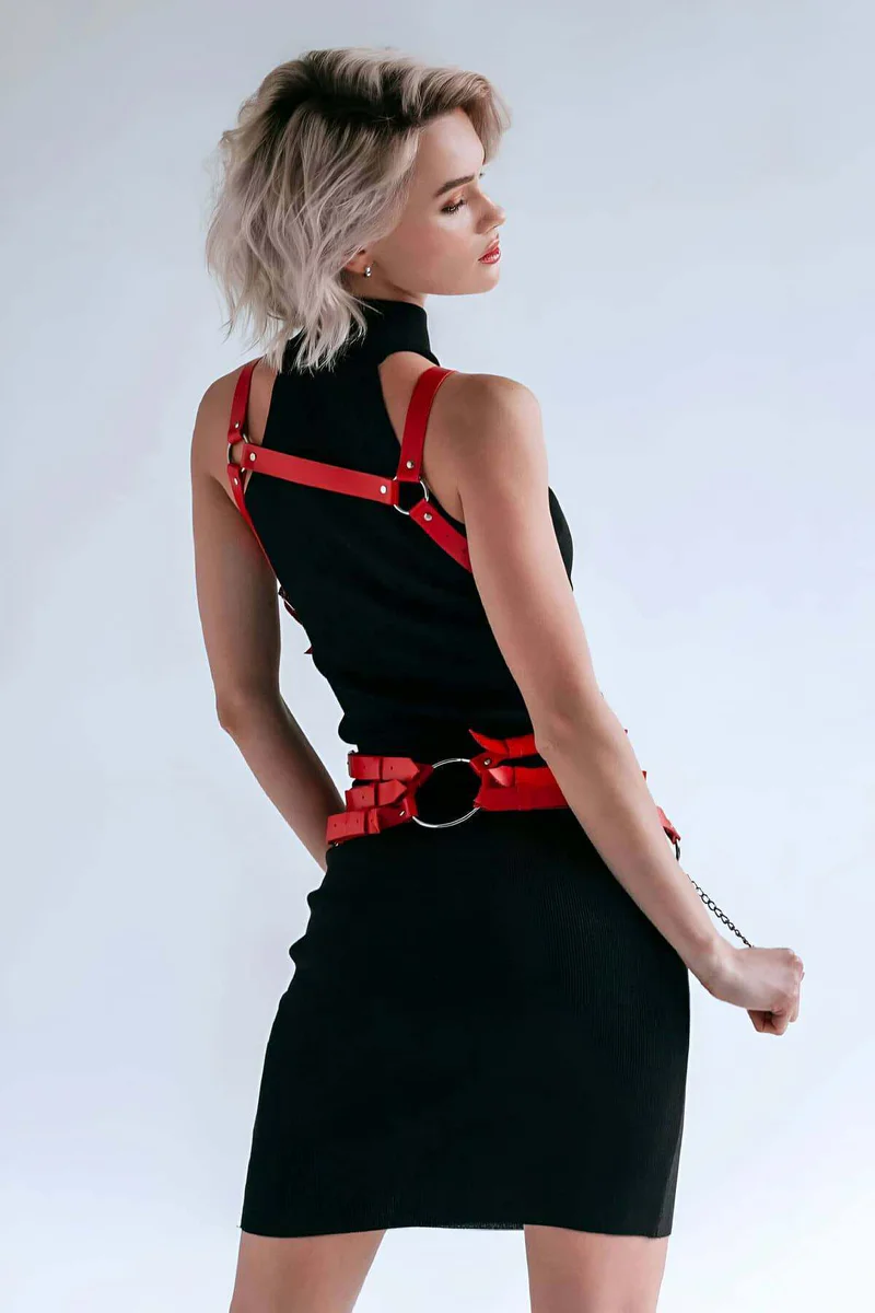 Red leather harness with silver O-ring and chain detail on skirt