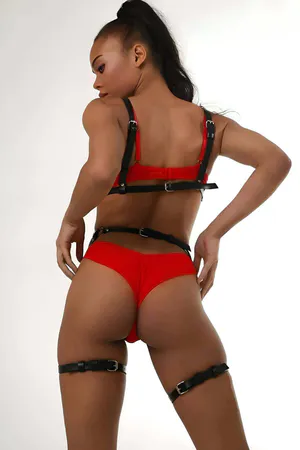 Black vegan leather full body harness with O-ring accents and adjustable straps.