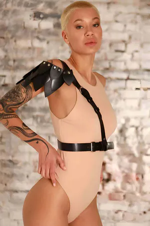 Black vegan leather asymmetrical shoulder harness with adjustable waist belt