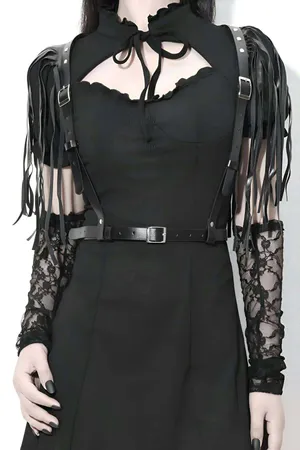 Black faux leather body harness with dramatic fringe shoulder straps and silver buckles.