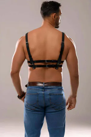 Black faux leather chest harness with adjustable straps and gunmetal hardware