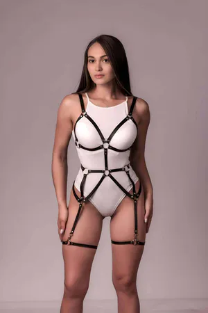 Black faux leather body harness with adjustable garter straps and O-ring accents