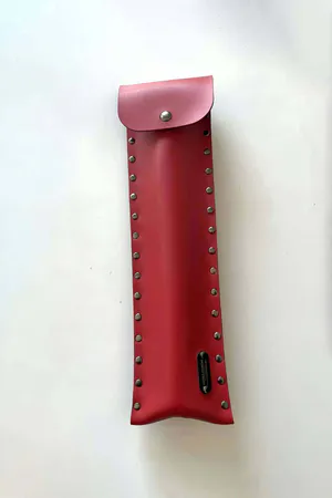 Red Faux Leather Flogger with Riveted Storage Pouch on grass