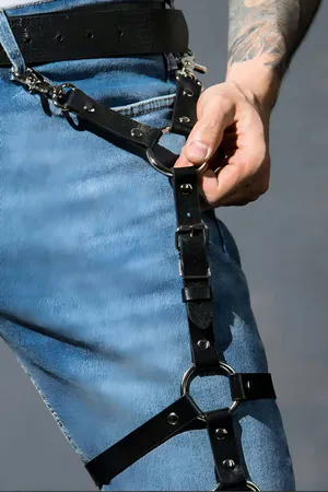 Black faux leather thigh harness with three O-rings and adjustable straps