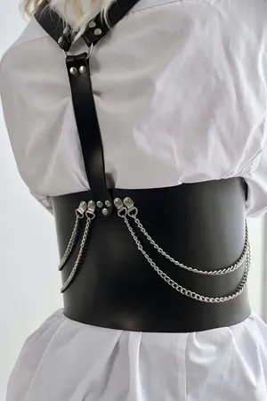 Black faux leather corset harness with double buckle straps and silver chain accents