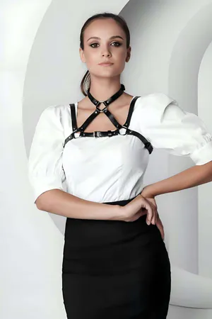 Black faux leather strappy O-ring chest harness on a model