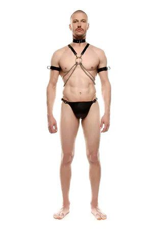 Black faux leather body harness with silver O-ring, layered chains, choker, and adjustable armbands.
