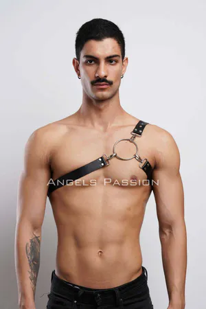 Black faux leather chest harness with silver O-ring and adjustable strap on a man