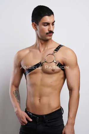 Black faux leather chest harness with silver O-ring and adjustable strap on a man