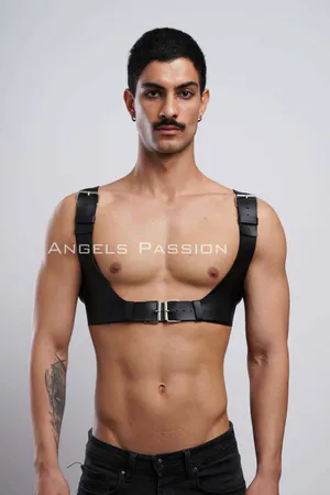 Black faux leather chest harness with silver buckle and adjustable straps on male model