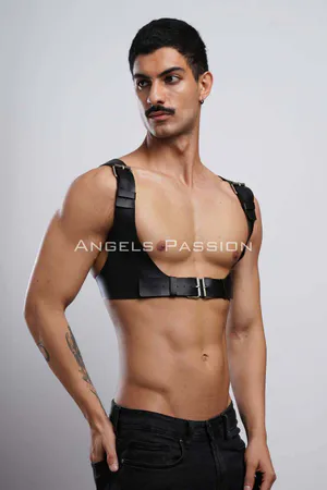 Black faux leather chest harness with silver buckle and adjustable straps on male model