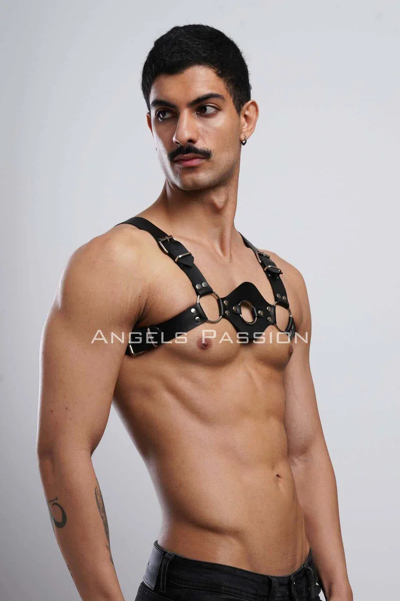 Close-up of silver O-ring and buckle hardware on black harness