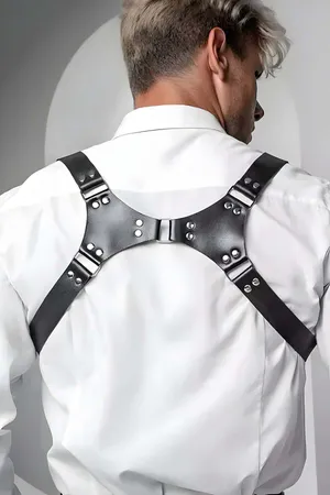 Black faux leather adjustable shoulder harness worn by a person