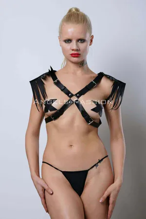 Black faux leather shoulder harness with cascading fringe detail on model's back