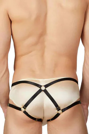 Champagne satin harness brief with black faux leather straps and gold O-ring accents